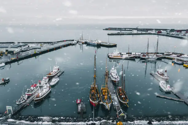Scenic aerial view of port with old ships in Husavik in winter