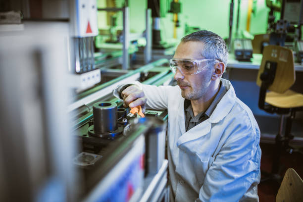 istock Focused mid adult engineer working on machinery in laboratory. 1127075275