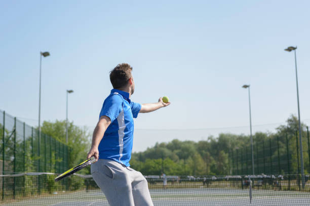 istock Mid adult man playing tennis game. 1127075955