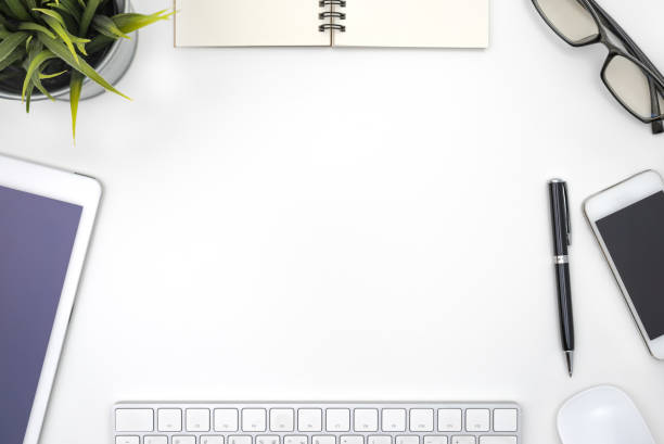 istock Frame with office equipment on white desk 1127076439