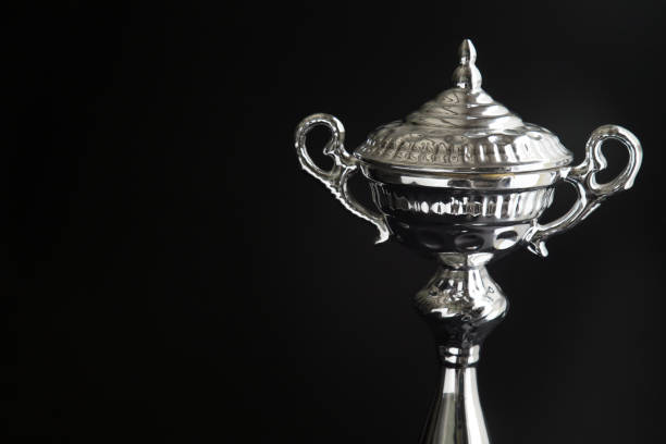 istock Close up of Silver trophy over black background. Winning awards with copy space for text and design 1127079043