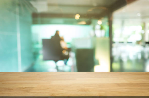 istock empty wooden desk over blurred coffee shop cafe background. 1127079475