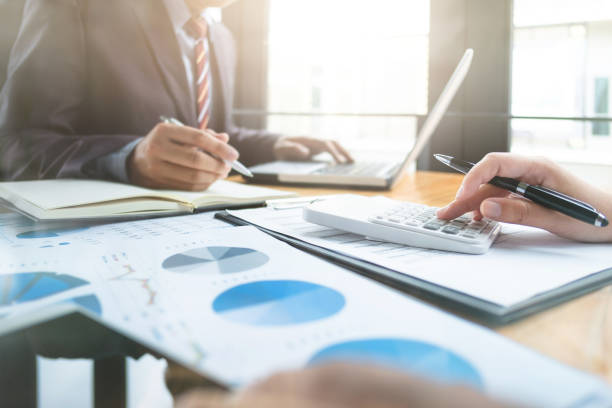 istock business audits using a calculator financial data investment fund at a workplace, wealth concept 1127079476