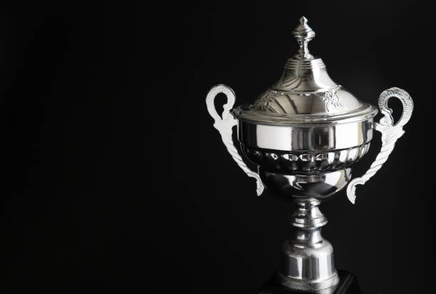 istock Close up of Silver trophy over black background. Winning awards with copy space for text and design 1127079560