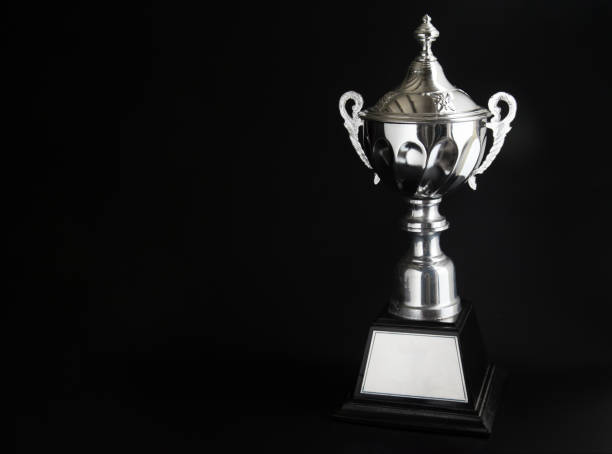 istock Silver trophy over black background. Winning awards with copy space for text and design 1127079561