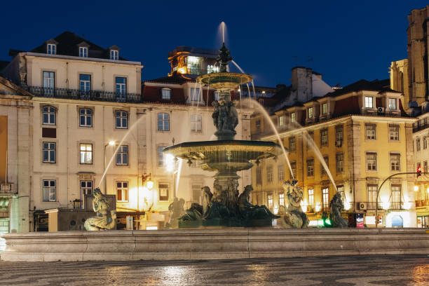 istock Fountain in Rossio square Lisbon at night time 1127080439