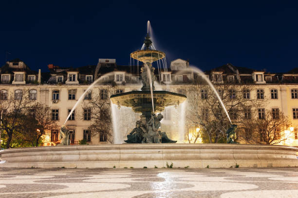 istock Fountain in Rossio square Lisbon at night time 1127080448