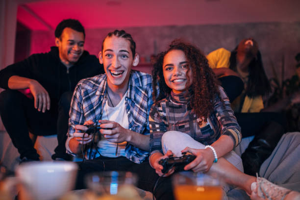 istock Young friends playing video games 1127080610