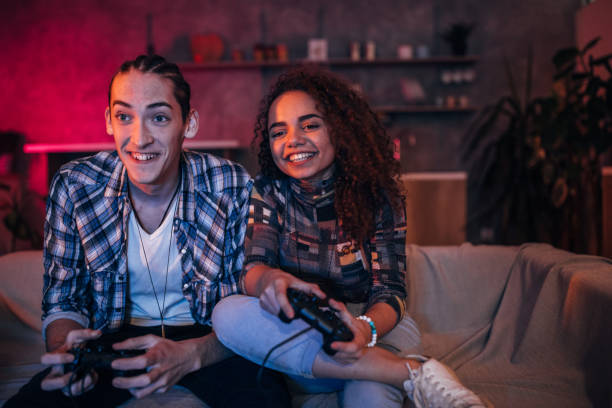 istock Young friends playing video games 1127081523