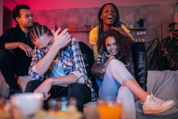 istock Young friends playing video games 1127081737