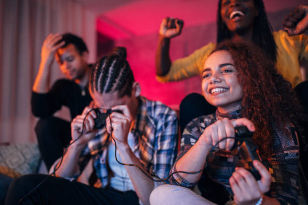 istock Young friends playing video games 1127081827