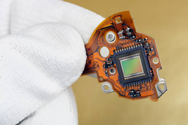 istock A technician controls the quality of a modern sensor for a photo camera. Masss production 1127082673