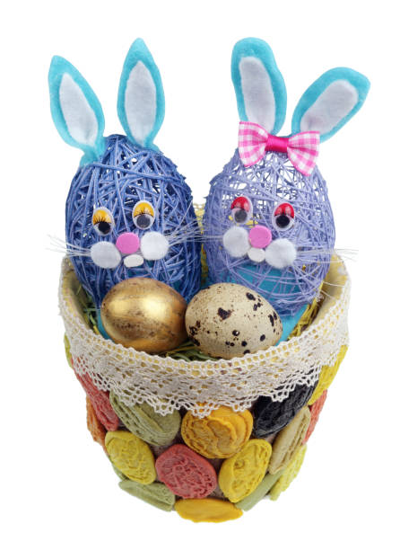 istock Easter handmade  nest  from  pasta with funny  bunnies and  quail egg. Isolated 1127082685