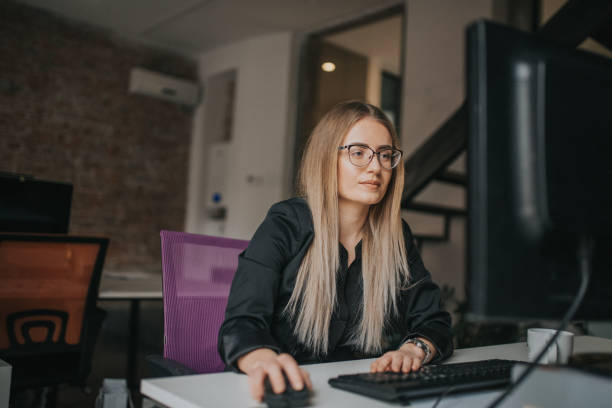 istock Businesswoman using computer and drink coffe at desk 1127083683