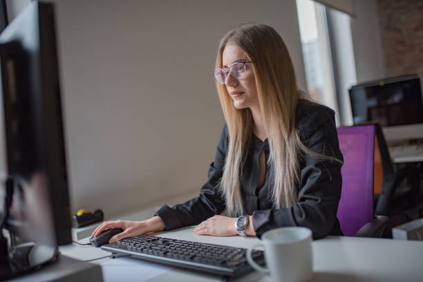 istock Businesswoman using computer and drink coffe at desk 1127083723