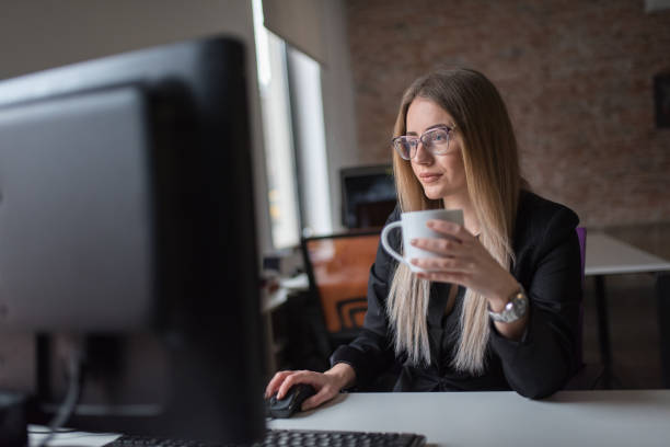 istock Businesswoman using computer and drink coffe at desk 1127083766