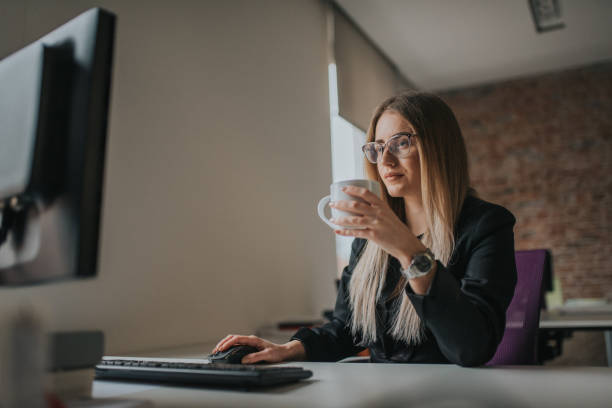 istock Businesswoman using computer and drink coffe at desk 1127083796