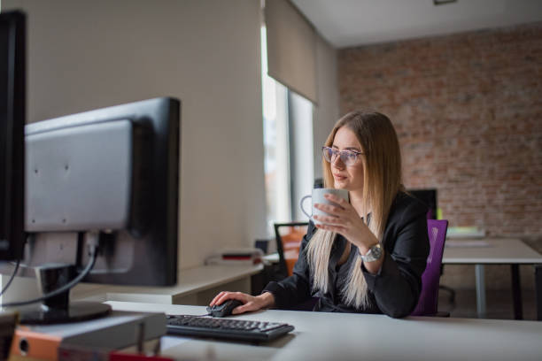 istock Businesswoman using computer and drink coffe at desk 1127083823