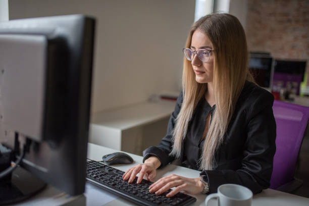 istock Businesswoman using computer and drink coffe at desk 1127083826