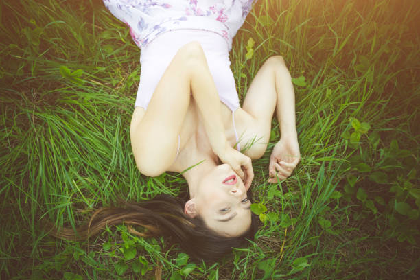 istock Caucasian girl in white dress lying 1127084073