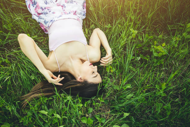 istock Caucasian girl in white dress lying 1127084852