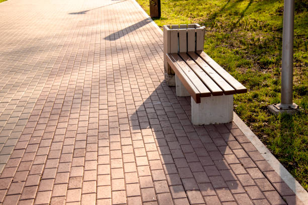 istock A beautiful brown empty bench stands in the Park on summer 1127085050