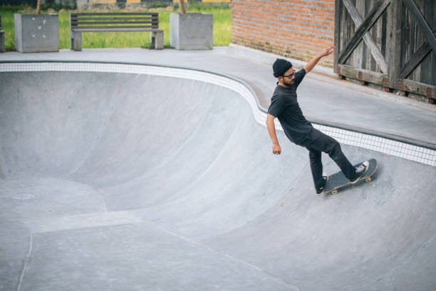 istock Man riding a skateboard at skateboard park 1127085119