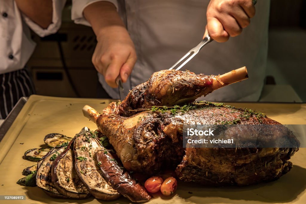 Carving Lamb Carving of Roasted lamb meat Large Stock Photo