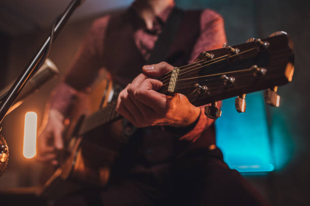 istock Rock musician singing and playing acoustic guitar 1127086557