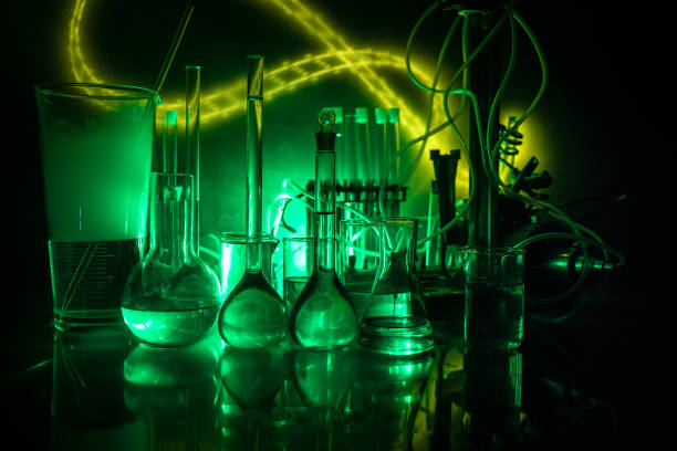 istock Pharmacy and chemistry theme. Test glass flask with solution in research laboratory. Science and medical background. Laboratory test tubes on dark toned background 1127088540