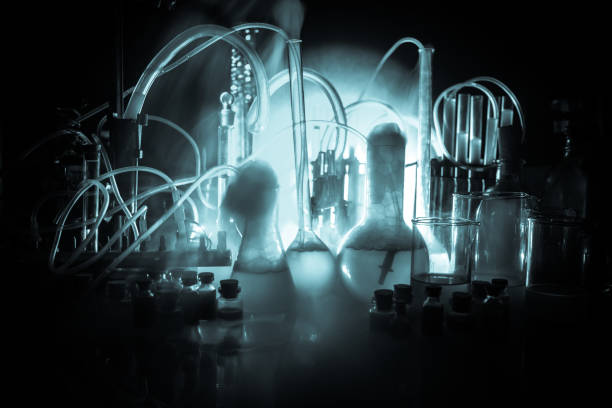 Pharmacy and chemistry theme. Test glass flask with solution in research laboratory. Science and medical background. Laboratory test tubes on dark toned background , science research equipment concept