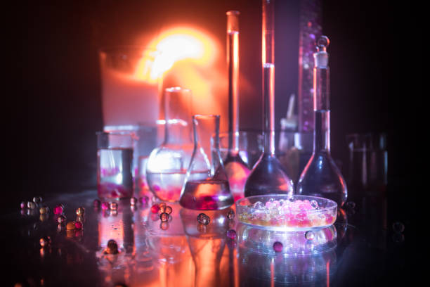 istock Pharmacy and chemistry theme. Test glass flask with solution in research laboratory. Science and medical background. Laboratory test tubes on dark toned background 1127088581
