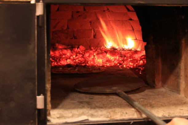 istock Baking italian pizza in brick oven 1127088968