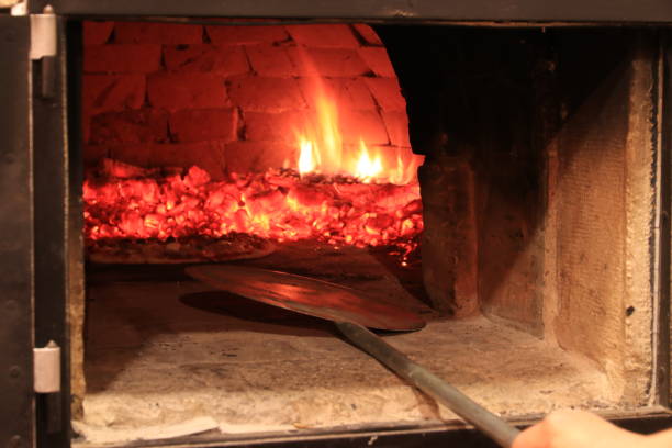 istock Baking italian pizza in brick oven 1127088969