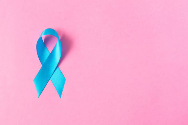 istock Blue ribbon.  Isolated on pink background with empty space for text. Close up. 1127089811