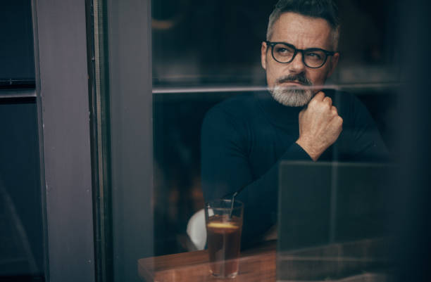 istock Mature man sitting in the coffee shop 1127090140