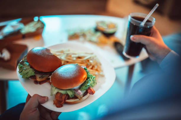 istock Fat man eating fast food 1127092976