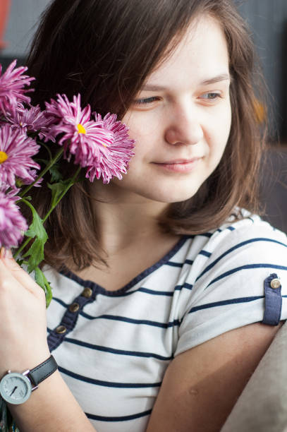 istock Girl with flowers 1127094875