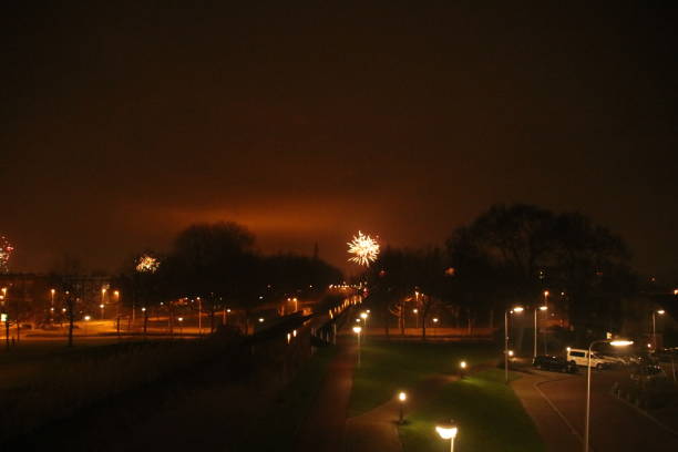several colors of firework exploding in the sky in Nieuwerkerk aan den IJssel in the Netherlands during new years eve.