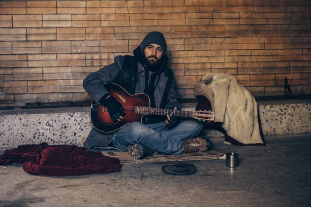 istock Homeless man playing guitar 1127096457