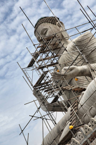 istock Large Buddha statue under a scaffold due to repairs 1127096988