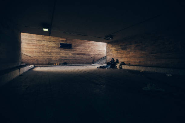 istock Homeless man playing guitar in underpass tunnel 1127097433