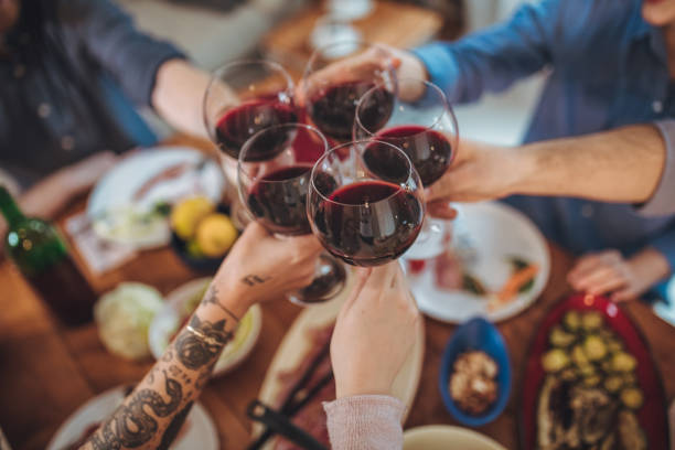 istock Friends making toast with wine glasses 1127098469