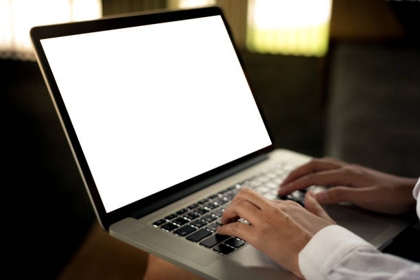 istock Woman hands typing laptop computer keyboard on her lap at the office with blank space display and sun flare effect- woman office worker and businesswoman concept 1127098485