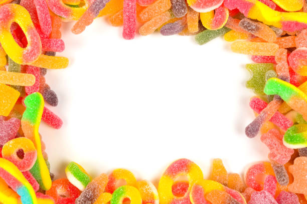 istock Frame of assorted gummy candies isolated on white. Top view. Space for text or design. 1127098873