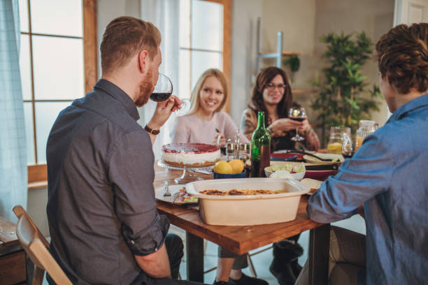 istock Group of friends enjoying lunch together 1127098971