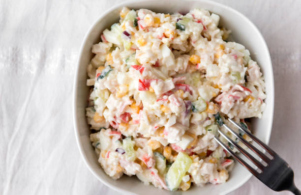 istock crab salad with cucumber egg, in a white plate on a white tablecloth, fork 1127100985