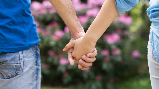Hand in hand concept Happy love couple holding hands outdoor couple holding hands stock pictures, royalty-free photos & images