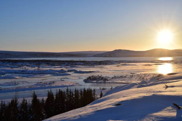 istock Sun Rising above snow covered landscape 1127103929
