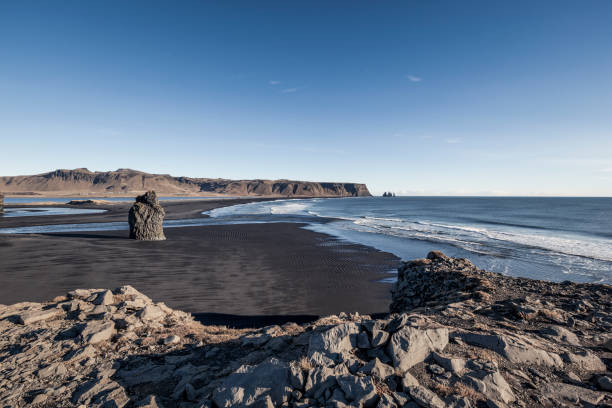 istock cape dyrholaey, arnardrangur on black sand beach, vik, iceland 1127106376